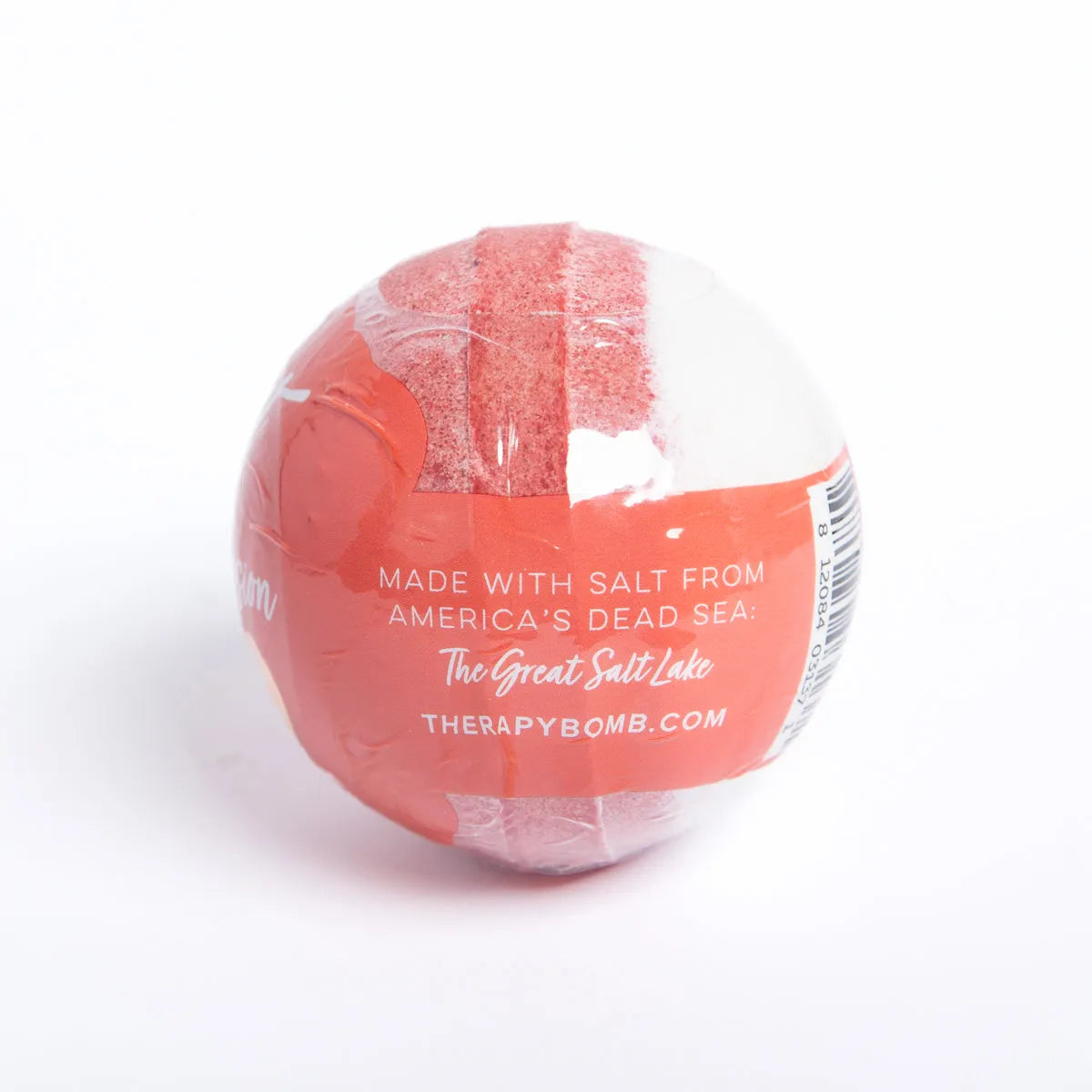 Round Hibiscus Passion bath bomb wrapped in clear plastic with red and white branding and Great Salt Lake text.