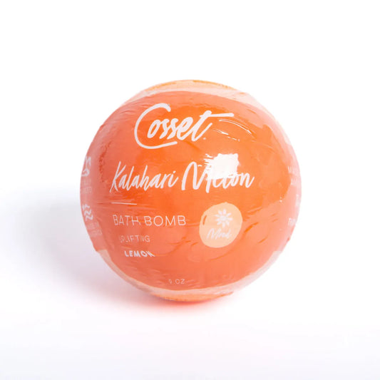 Round, 9 oz orange Kalahari Melon bath bomb wrapped in clear plastic with white text and lemon scent branding.